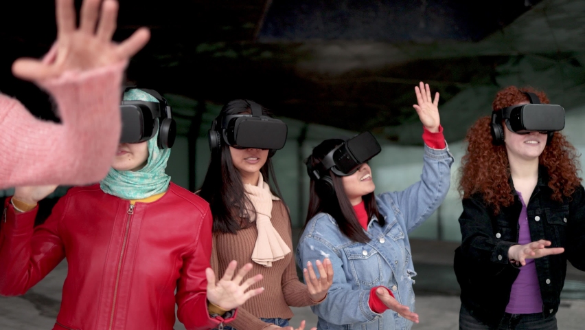 Young multiracial people having fun using virtual reality headset - Metaverse futuristic entertainment Royalty-Free Stock Footage #1093435151