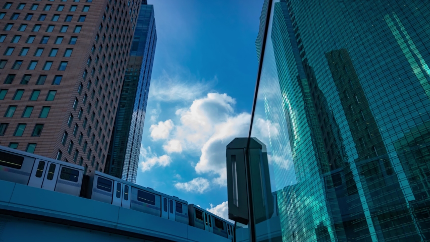A timelapse of cloud reflecting the building in the business town wide shot tilt. High quality 4k footage. Minato district Shiodome Tokyo Japan 07.25.2022 Here is a center of the city in Tokyo. 