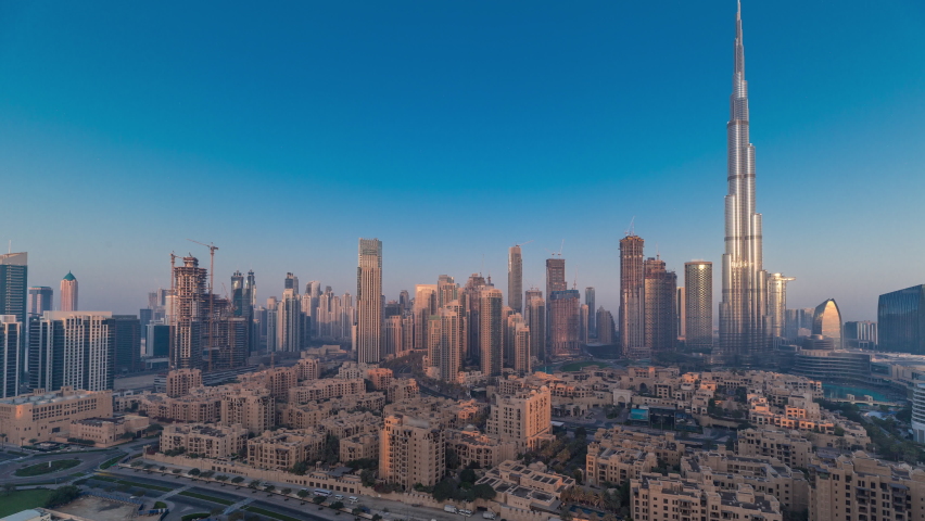 Dubai Downtown morning panoramic timelapse with sun reflected from tallest skyscraper and other towers view from the top during sunrise with long shadows moving fast, United Arab Emirates Royalty-Free Stock Footage #1093441229