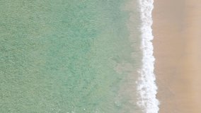 Beautiful Aerial view of drone Turquoise beach sea sand copy space. 4K Nature video travel tourism concept. Seawater wave and surf on sandy beach. Beach space area background. 4K ProRes HQ 4:2:2