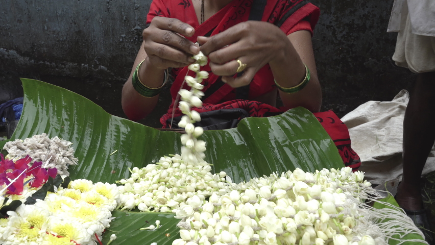 Closeup of a hand making flower garland, Mumbai, India Royalty-Free Stock Footage #1093459015