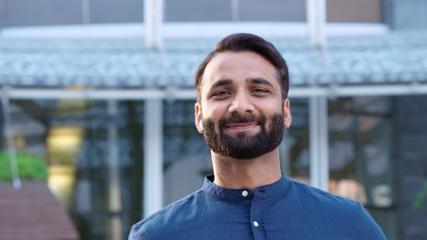 Smiling wealthy confident Indian ethnic business man, eastern professional businessman wearing blue shirt looking at camera with arms crossed standing outdoors in urban city, headshot portrait. | Shutterstock HD Video #1093463231