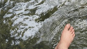 Video footage of My feet that try to make rippling water at a river