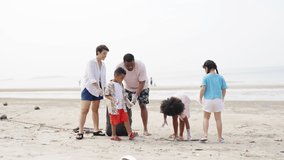 4K Group of Diversity family on summer holiday vacation. Parents teaching children kid picking up plastic bottle and garbage on the beach. Environment protection volunteer and waste pollution concept - Powered by Shutterstock - Get 15% off with code: PIKWIZARD15