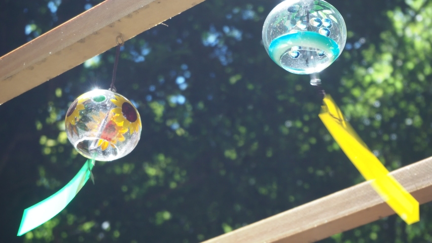 A wind chime gently swaying in the wind Royalty-Free Stock Footage #1093466161