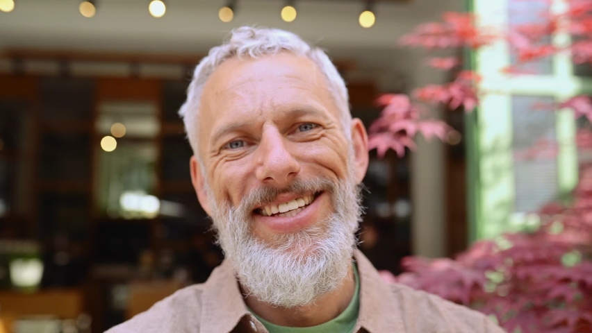 Happy smiling middle aged old grey-haired bearded man laughing outdoors. Cheerful senior adult male entrepreneur, european small business owner close up headshot portrait in slow motion. | Shutterstock HD Video #1093471975