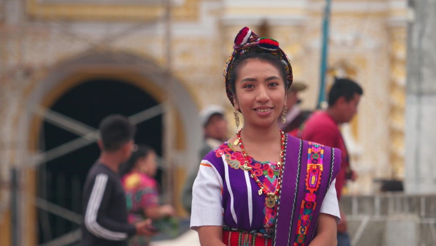 Portrait of a young woman with a colorful dress in the town square of Zunil Quetzaltenango. Royalty-Free Stock Footage #1093478253