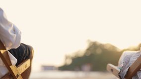 Happy Asian family senior couple enjoy outdoor lifestyle on summer beach holiday vacation at the sea. Elderly retired man and woman relaxing on beach chair and holding hands together at summer sunset - Powered by Shutterstock - Get 15% off with code: PIKWIZARD15