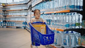 Excited Asian girl runs with blue shopping cart in supermarket. Preschooler child enjoys going shopping for food to market. Naughty daughter plays in shop - Powered by Shutterstock - Get 15% off with code: PIKWIZARD15