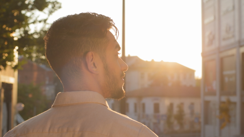 Back view from behind stylish man in formal shirt pensive calm dreaming businessman director boss ambitions planning thinking standing in city outdoor looking at sunset sunlight male silhouette in Royalty-Free Stock Footage #1093498457
