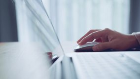 B roll - Close-up of a woman hand using white wireless mouse. female hand scrolling the wheel of a light wireless mouse. - Powered by Shutterstock - Get 15% off with code: PIKWIZARD15