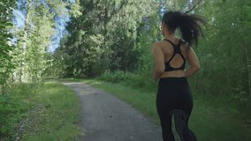 Fit Italian woman running in nature feeling vital