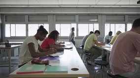 Teacher walks in the classroom explaining Lesson to class of Teenager students Learning at High School College - Powered by Shutterstock - Get 15% off with code: PIKWIZARD15