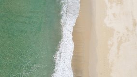 Top-view Aerial view of drone Turquoise beach sea sand copy space. 4K Nature video travel tourism concept. Seawater wave and surf on sandy beach. Beach space area background. 4K ProRes HQ 4:2:2