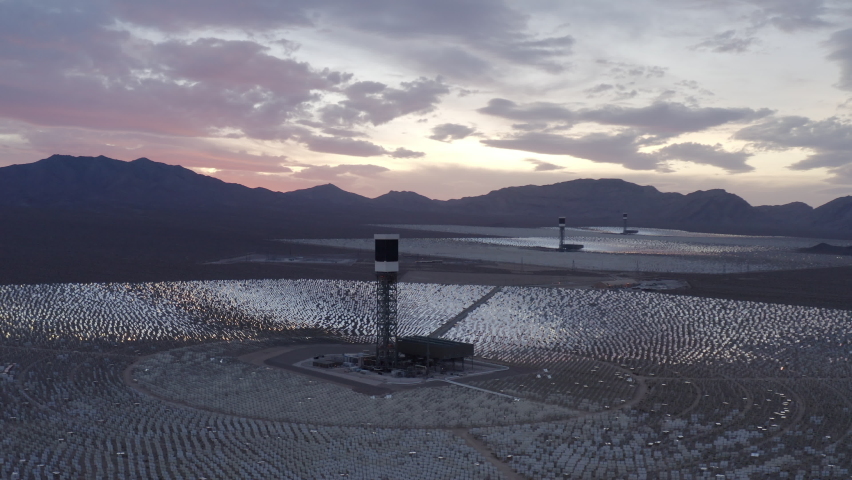 Aerial Panning Shot Of Solar Energy Company In Mojave Desert Under Cloudy Sky During Sunset - Nipton, California