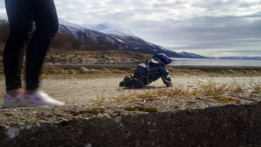 Baby Boy Crawling On Jetty Towards Water Puddle During Winter - Tromso, Norway