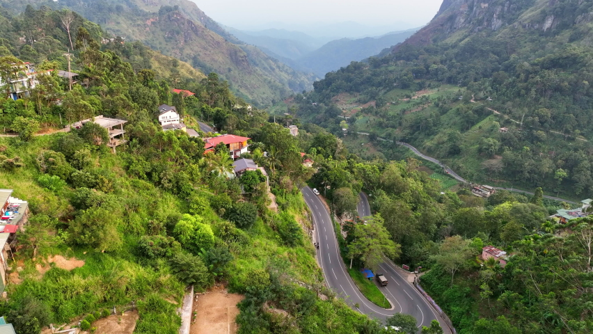 Aerial Shot Of Vehicles Moving On Road Amidst Green Trees, Drone Flying Forward Over Mountains - Ella, Sri Lanka Royalty-Free Stock Footage #1093523785