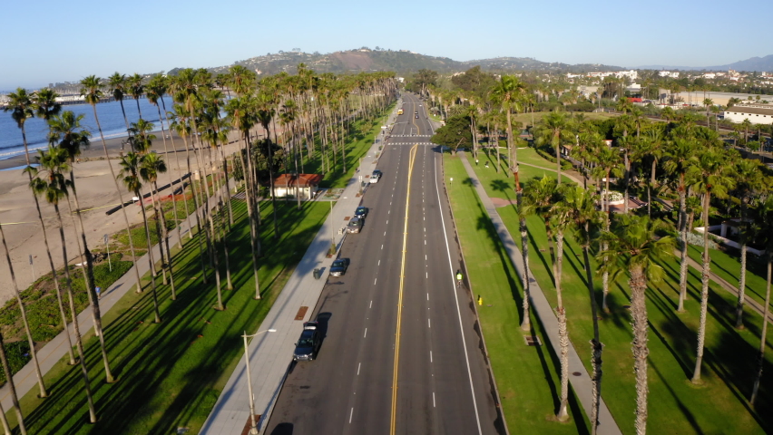 Aerial Forward Shot Of Road Amidst City Landscape And Beach On Sunny Day - Santa Barbara, California Royalty-Free Stock Footage #1093525385