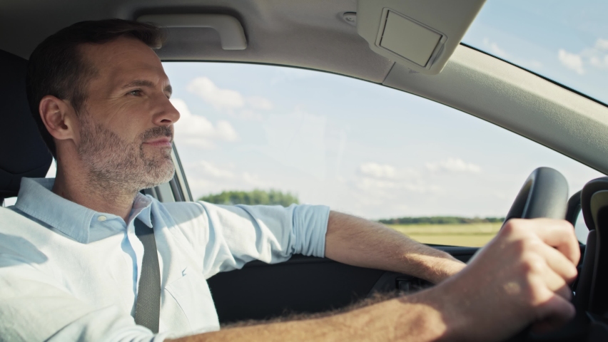 Caucasian man of middle age driving a car. Shot with RED helium camera in 8K.