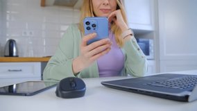 Woman using modern mobile phone for communication online. 4k stock video of white female browsing mobile app on modern blue smartphone with triple camera. Freelancer person communicating social media 