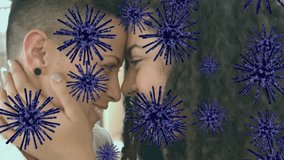Animation of virus cells over happy diverse lesbian couple hugging. Health and medicine during covid 19 pandemic concept digitally generated video.
