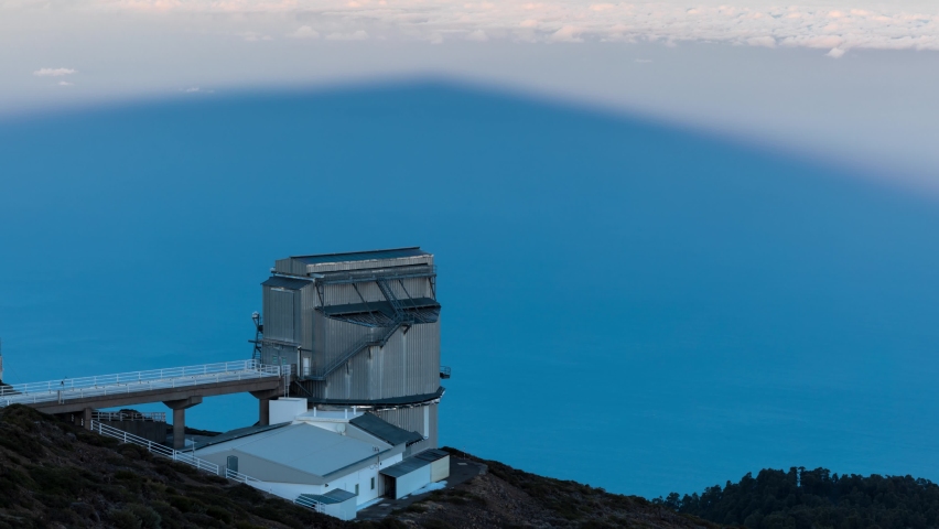 Time-lapse. Roque de los Muchachos Observatory. The sun rises into the sky, gradually revealing an observatory immersed in shadow