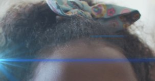 Animation of light trails over african american schoolgirl. Global education and learning concept digitally generated video.