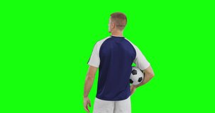 Video of caucasian male soccer player with ball on green screen background. Soccer, football, sports and competition concept.