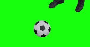 Video of legs of african american male soccer player kicking ball on green screen background. Soccer, football, sports and competition concept.