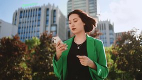 attractive asian woman with smartphone in urban landscape, portrait on city street, businesswoman - Powered by Shutterstock - Get 15% off with code: PIKWIZARD15