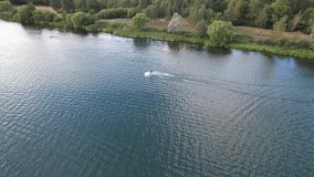 Beautiful Aerial Drone's Camera  Footage of Willen Lake and Park which is located at Milton Keynes, England.People are Enjoying at Lake on a Hot Sunny Day of Summer. Video Clip Captured on 21-8-2022