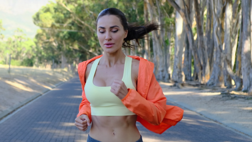 Good sporty morning. Cheerful girl running in park, healthy lifestyle. Young fitness sport woman running and Sportive people training in a urban area. young attractive fitness girl jogging Royalty-Free Stock Footage #1093567383
