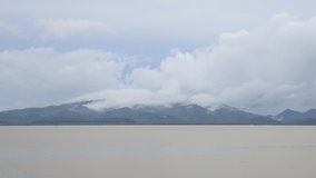 Time lapse clouds movement on blue sky over mountain and river, Nature and Environment, Video 4K