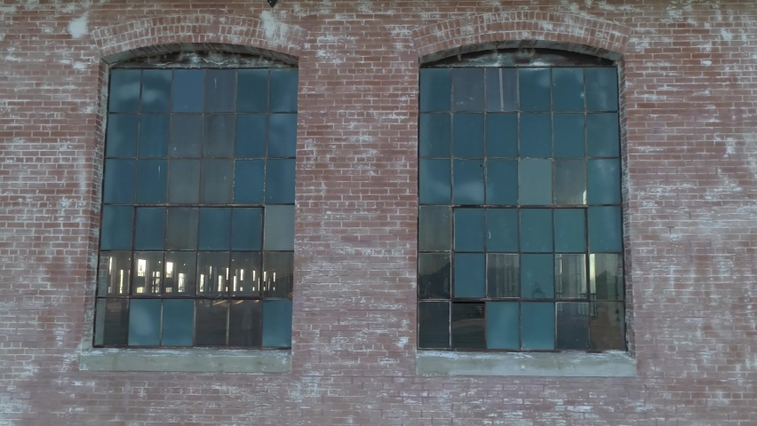Old abandoned cotton mill warehouse with sunlight filling the empty room during sunrise in McKinney Texas Royalty-Free Stock Footage #1093569997