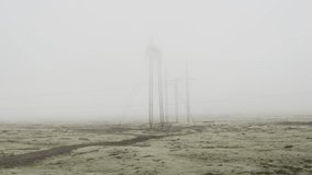 Giant electrics poles surrounded by lava fields in Iceland. Fog atmosphere 
 - Powered by Shutterstock - Get 15% off with code: PIKWIZARD15