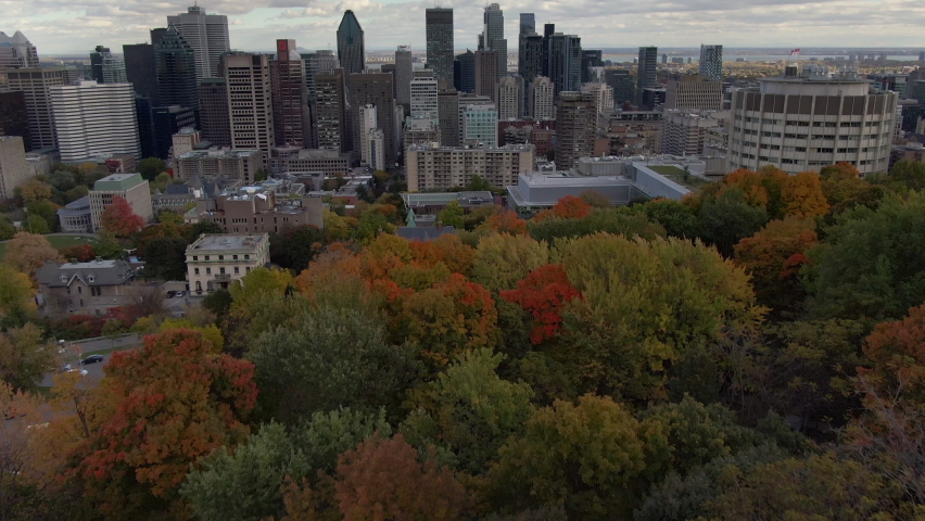 Aerial tilt up shot showing high rise buildings in the financial district of Montreal during fall season in Quebec, Canada. 
