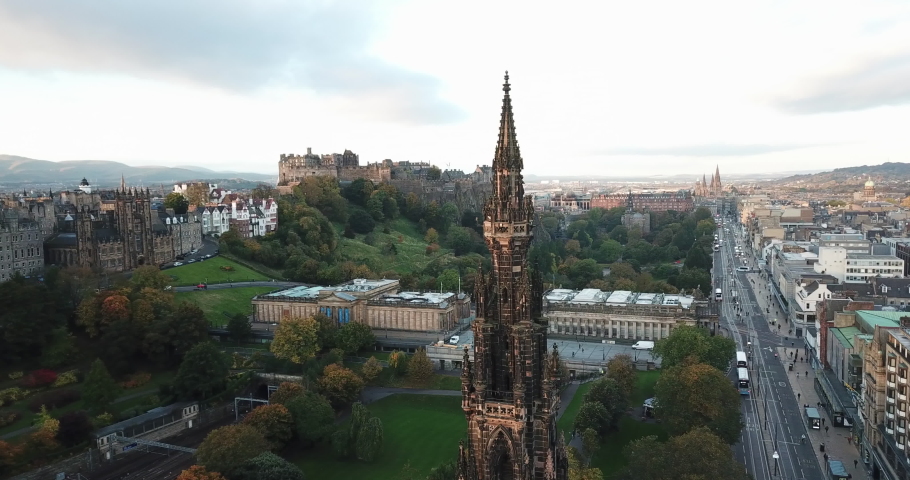 Rare drone shot of Edinburgh city above Scott Monument. The clip pans around the monument giving a panoramic view of the city at sunrise.