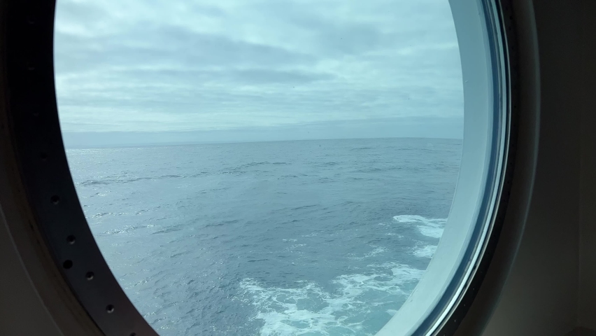 Rough seas through a big porthole on a luxury cruise ship | Shutterstock HD Video #1093580809