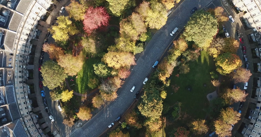 Spectacular drone shot of Moray Estate, Edinburgh, showcasing the beautiful colours of the trees against the white stone.