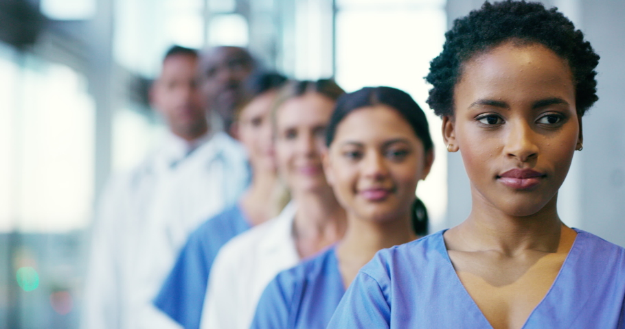Workforce ready for medical service with trust in line standing at hospital, collaboration at clinic and working in medicine as team. Portrait of healthcare workers showing success and trust Royalty-Free Stock Footage #1093585635