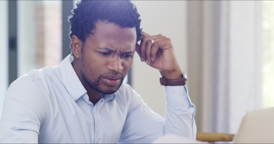 Anxiety, debt and stress with man looking at financial paperwork audit, trouble paying insurance loans or credit card on laptop. Confused and frustrated man worried about bills, tax and mortgage | Shutterstock HD Video #1093585669