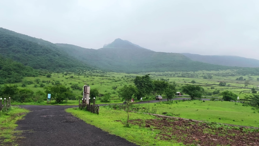 Traffic on a mountain road during the monsoons near Pune India. Monsoon is the annual rainy season in India from June to September.
