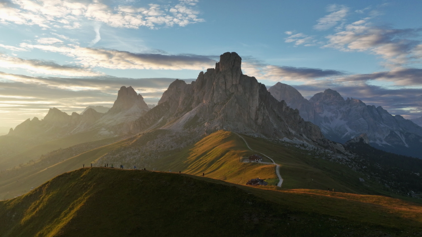 View from above, stunning aerial view of the Giau pass during a beautiful sunset. The Giau Pass is a high mountain pass in the Dolomites in the province of Belluno, Italy Royalty-Free Stock Footage #1093586915