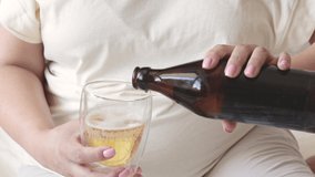 pregnant woman pour beer from bottle to glass.big advanced belly in background.third trimester.female wish to drink cold beverage in hot summer day.alcohol damage the health forbidden for pregnant - Powered by Shutterstock - Get 15% off with code: PIKWIZARD15