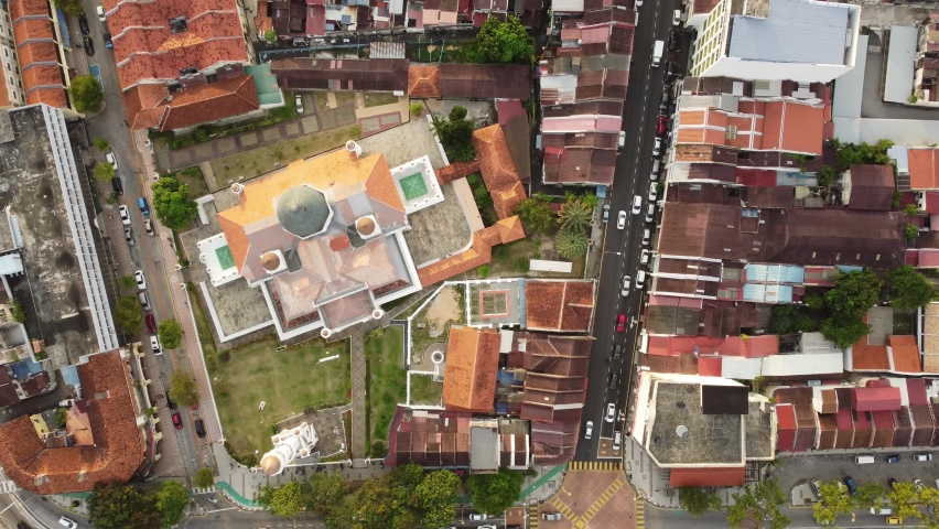 George Town, Malaysia: Aerial top down drone footage of the historic George Town UNESCO city center with the Kapitan Keling Mosque in Penang island. Shot with an upward and rotation motion