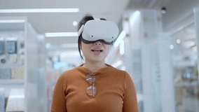 asian female woman wear virtual headset goggle while walking shopping in department store mall digital online purchase in virtual reality world new up coming technology trend today