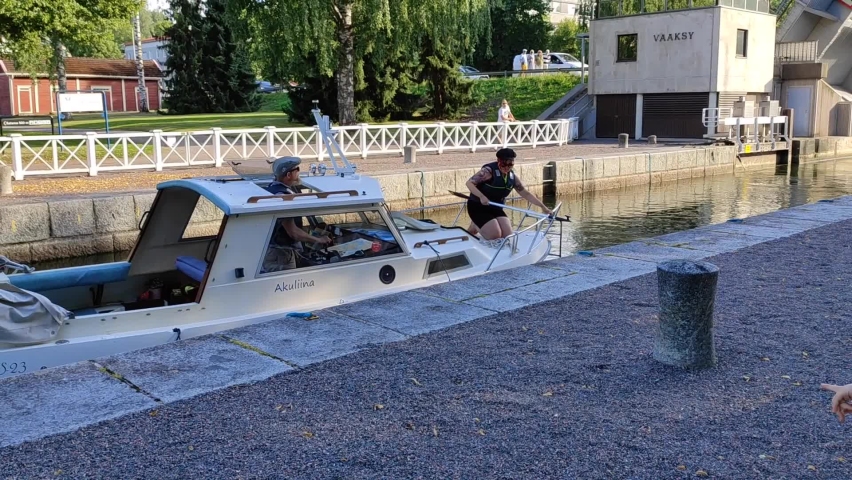 Vääksy Finland August 1, 2022: Vääksy town, Canal with water locks between two lakes Vessijärvi and Päijänne. Motor boats with tourists make the crossing.