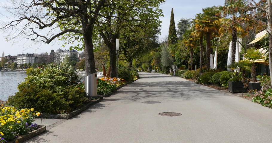 Montreux, Switzerland. Panorama of the promenade of Lake Geneva in spring with palm trees and flowers.