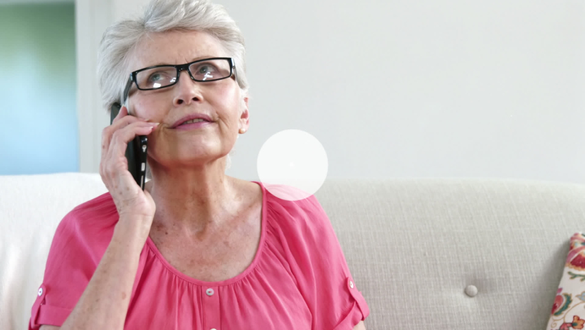 Animation of technology icons connecting with lines over senior caucasian woman talking on cellphone. Digital composite, multiple exposure, telecommunication, retirement. Wireless technology, home.