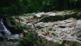 Video of a rocky hill with a water puddle below it